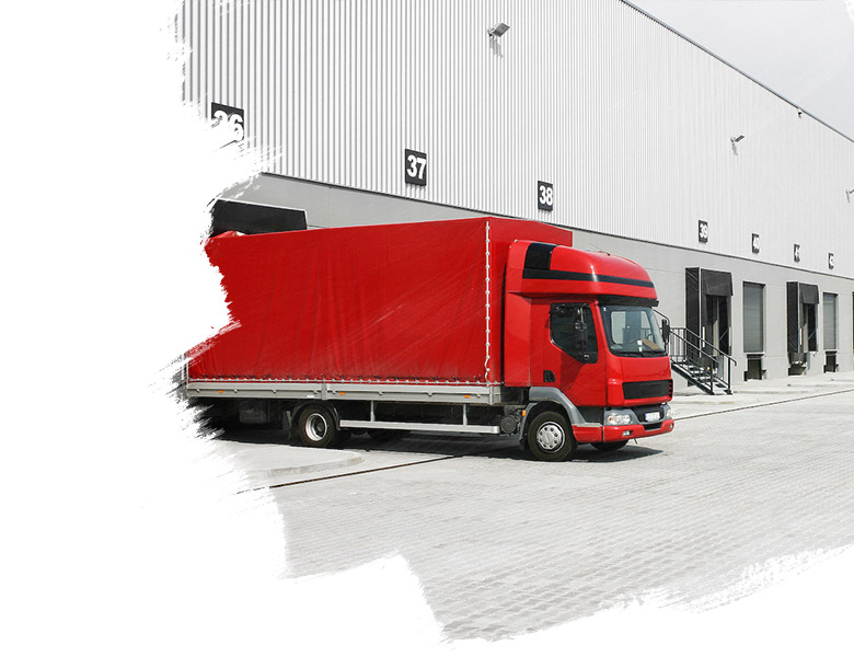 A commercial warehouse parking exterior with a red and white semi-truck